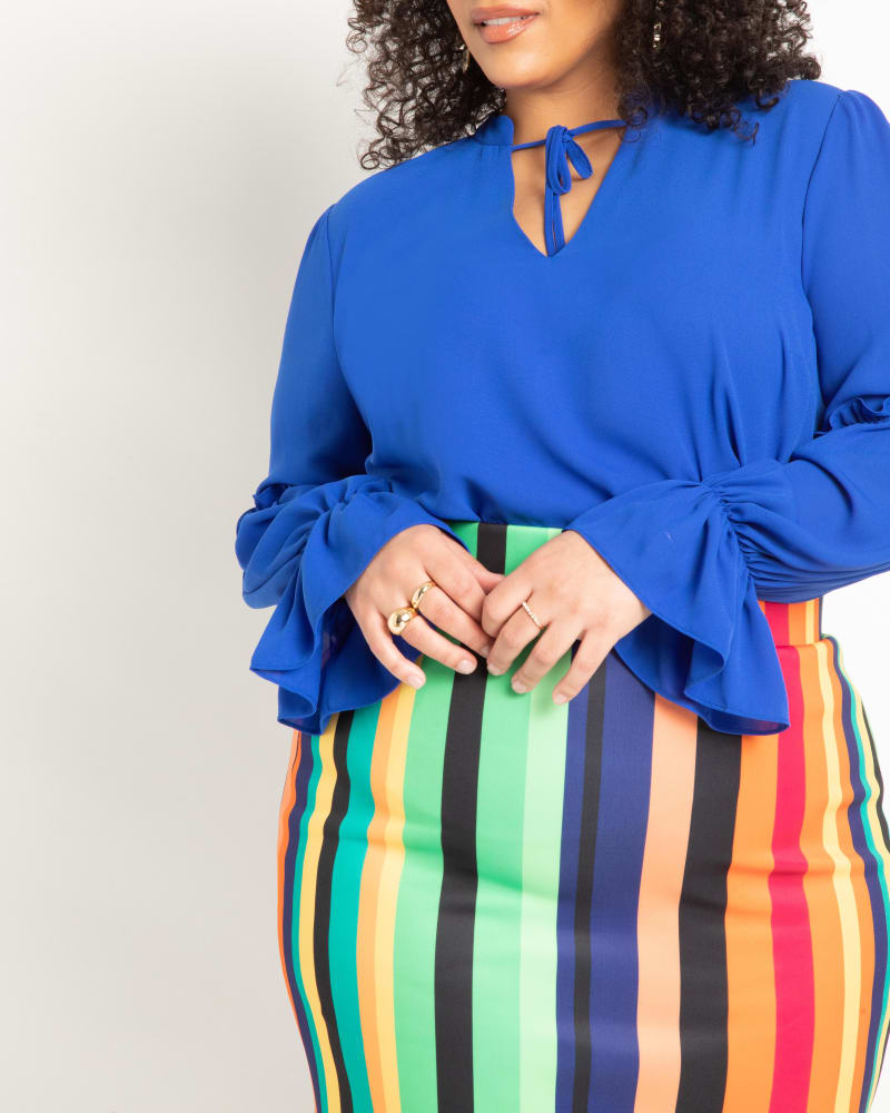 Side of a model wearing a size 16 Ruffle Detail Blouse With Ties in Cobalt by ELOQUII. | dia_product_style_image_id:295075